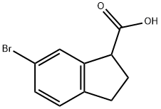 52651-16-8 6-ブロモ-2,3-ジヒドロ-1H-インデン-1-カルボン酸